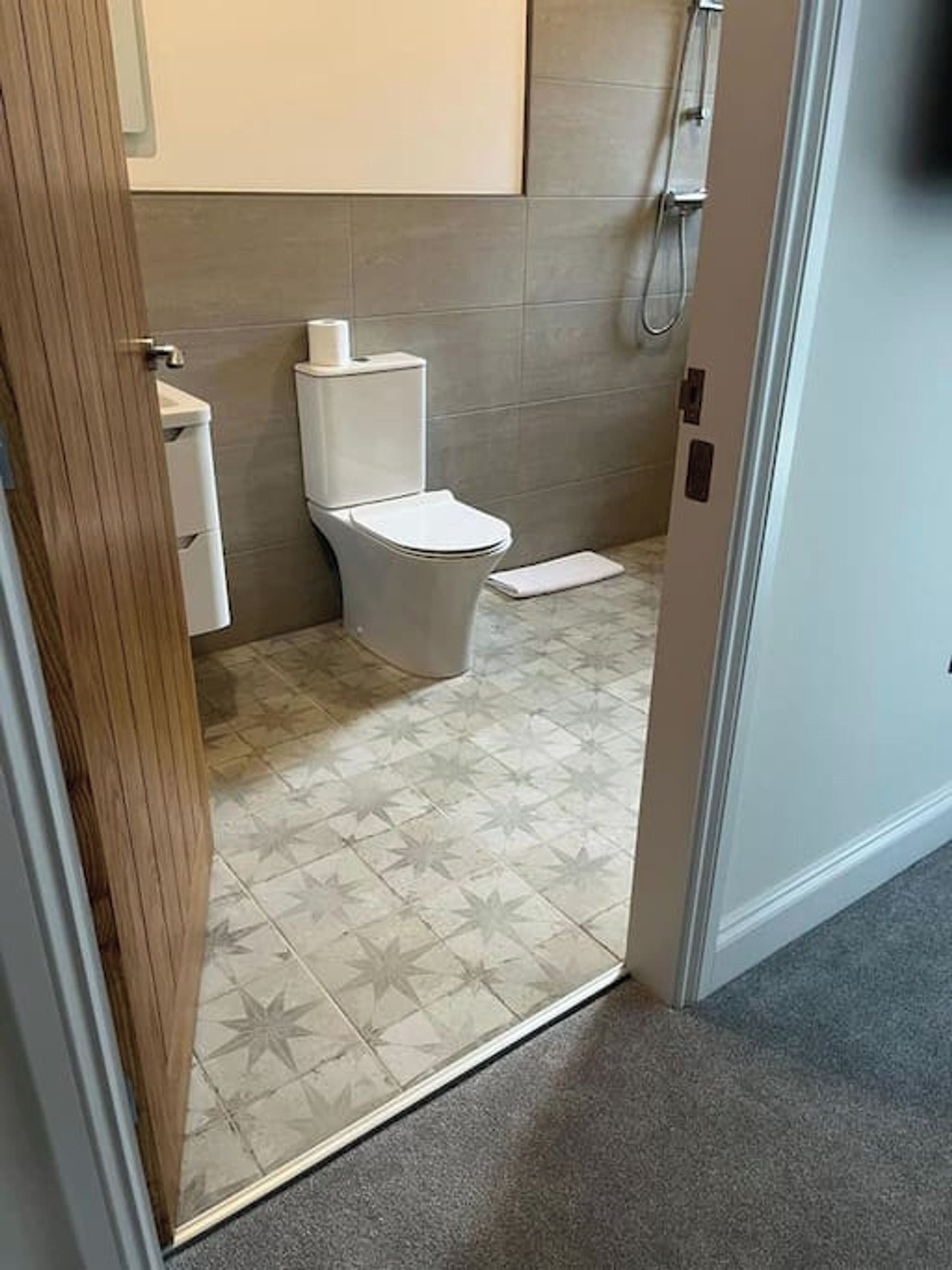 A bathroom with a toilet, a sink, and a shower.
