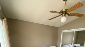 A room with two beds, a ceiling fan, and a large mirror. - Honeysuckle-bachelor/bachelorette parties welcome! (Lake Ozark)