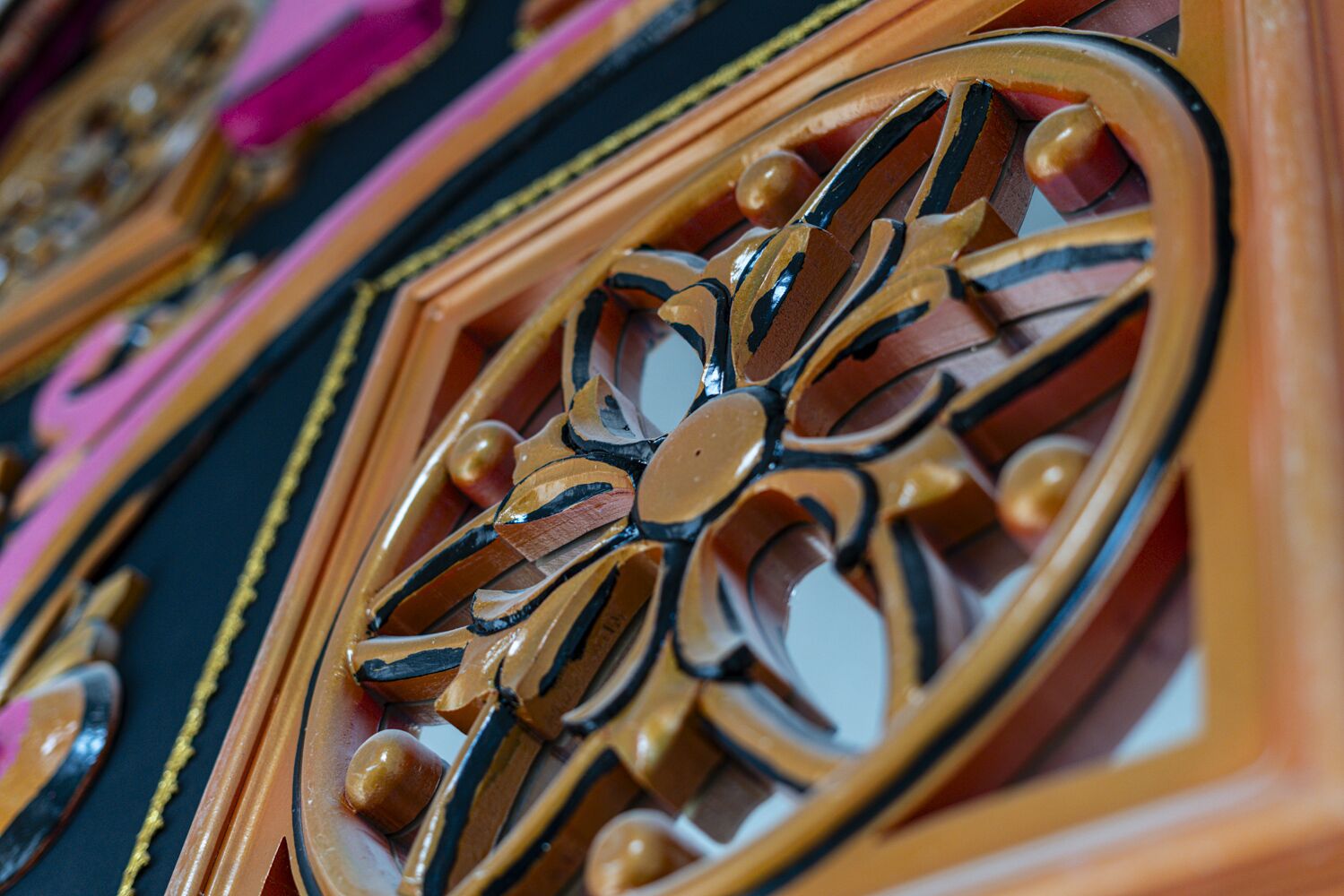 A close-up of a decorative metalwork with a floral pattern.