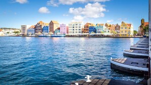 A waterfront cityscape with colorful buildings along the shore. - Fabulous Chic Apartment Filled w Natural Light at Famous Handelskade (Willemstad)