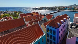 A coastal town with colorful buildings and a marina.