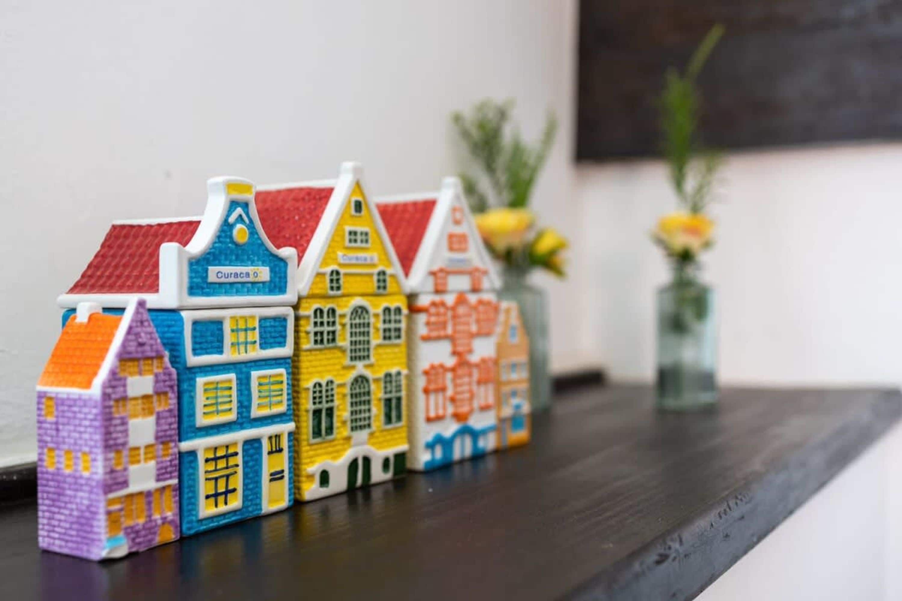 Miniature model houses on a shelf.