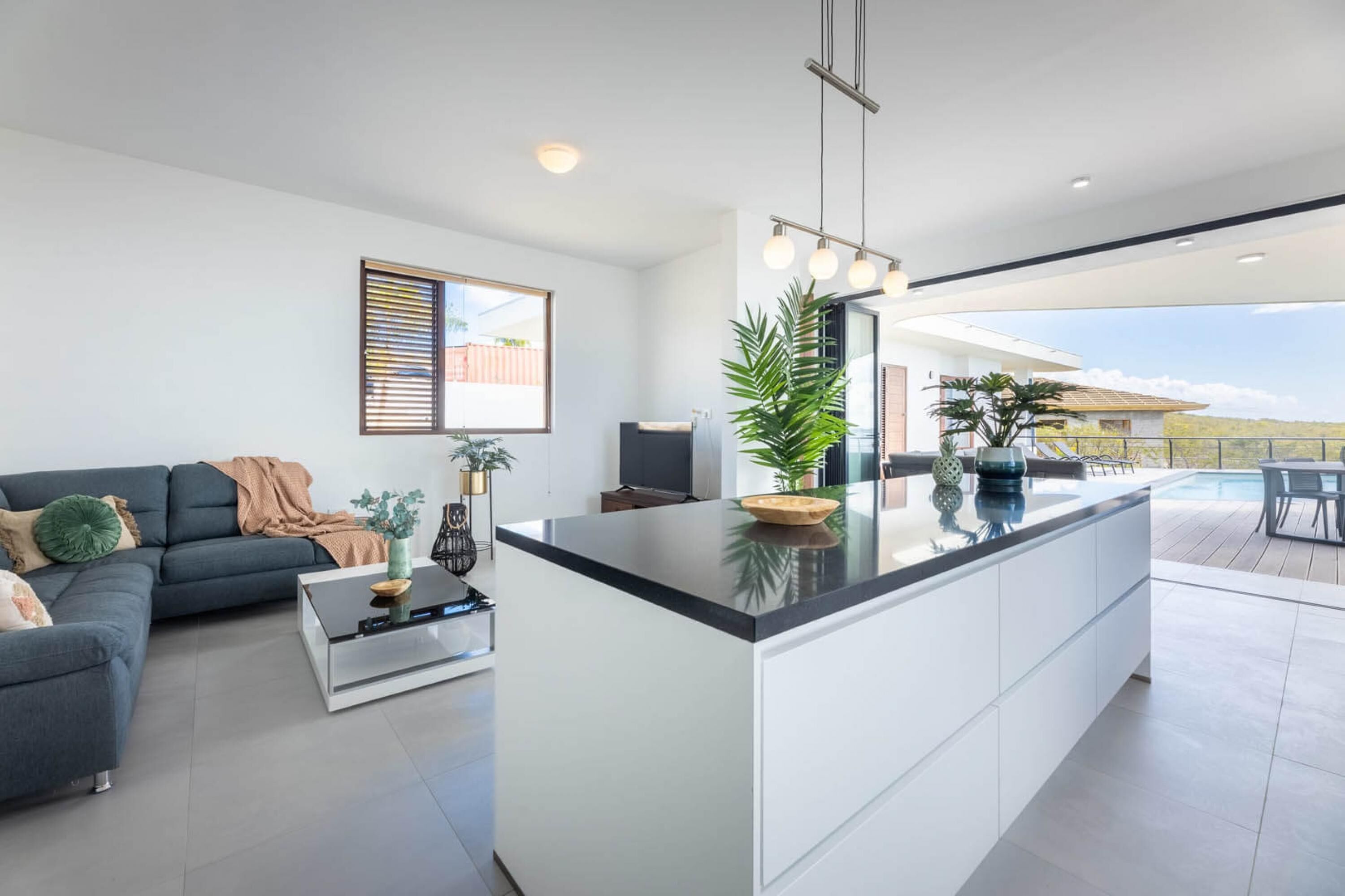 A modern living room with a large island, a sofa, and a coffee table.