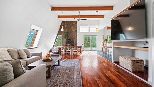 A spacious living room with a fireplace, wooden flooring, and a large TV mounted on the wall. - Charming Retreat near Healdsburg – 3 BD + Den, Outdoor Dining (Healdsburg)
