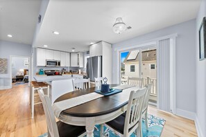 Enjoy meals in the kitchen with stainless steel appliances and a dining area with a table and chairs.