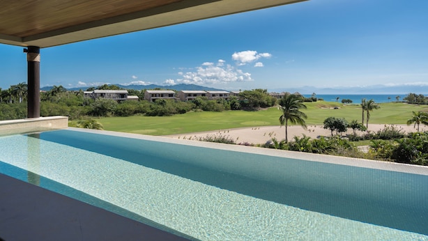 A pool with a view of a golf course and mountains. - Lux Ocean & Bay Views, Full Access, 2 Golf Carts, Plunge Pool, Cook/Cleaning (Punta de Mita)