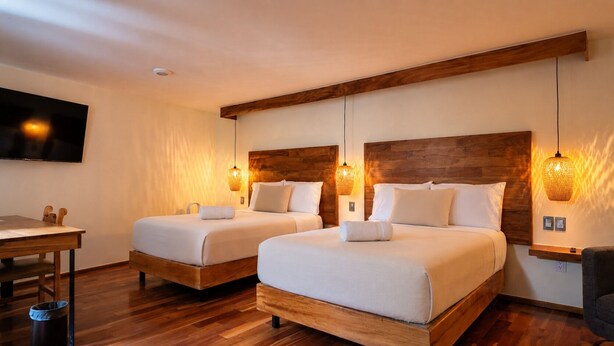 A hotel room with two beds, wooden headboards, and wall-mounted lamps. - Terraza & Loft San Ángel (Mexico City)