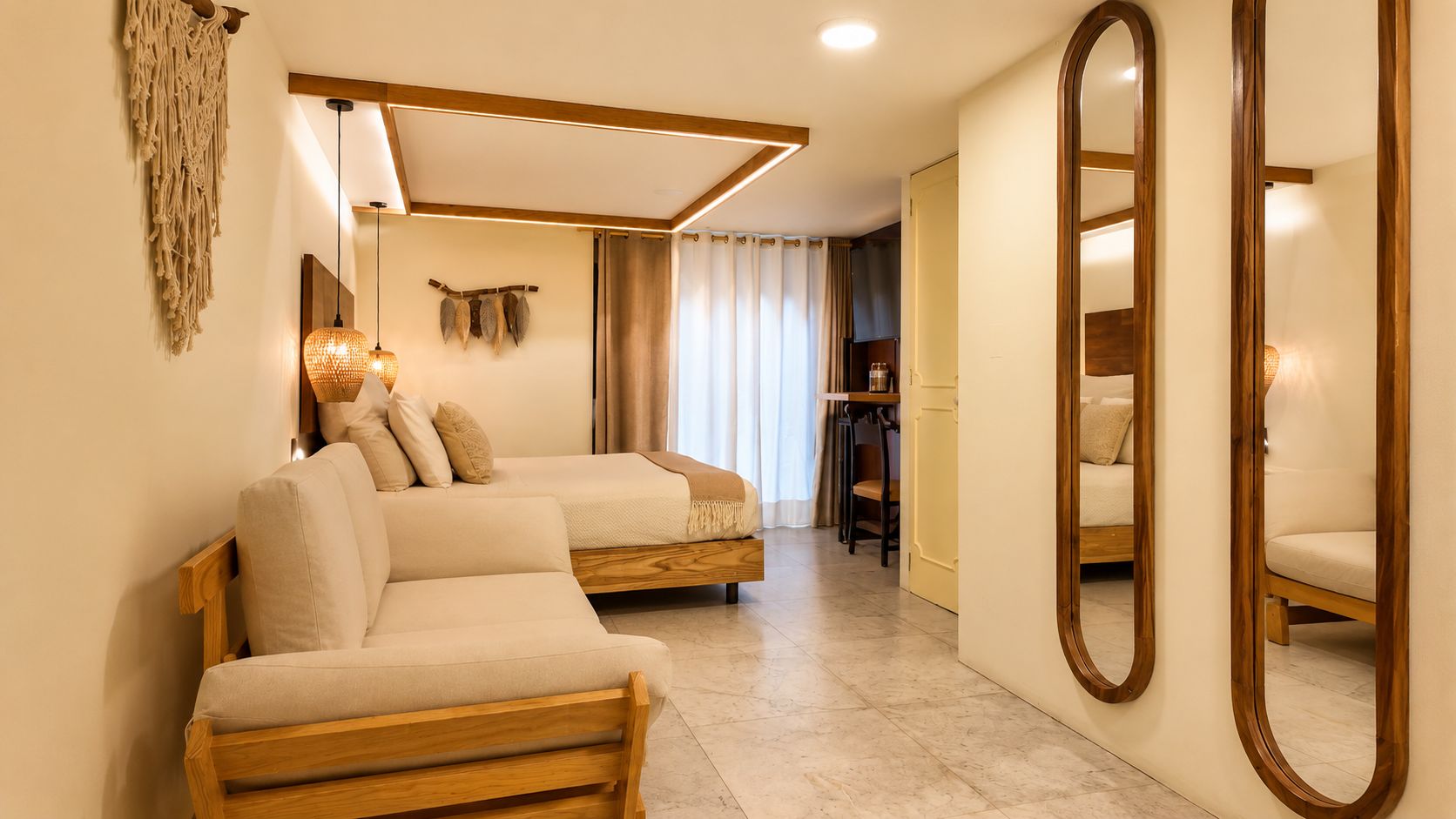 A hotel room with two sofas, a large mirror, and a wooden ceiling.