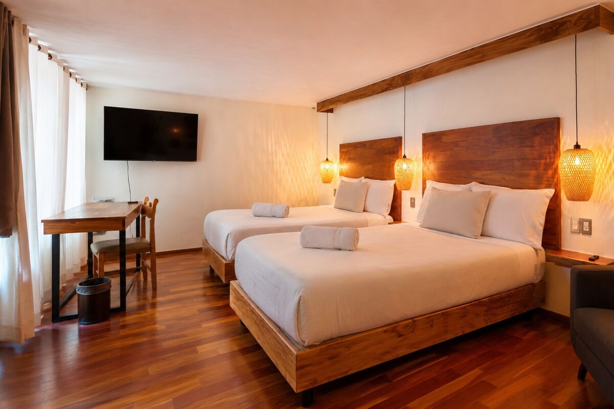 Deluxe Quadruple Room, Courtyard View | Premium bedding, desk, laptop workspace, blackout drapes