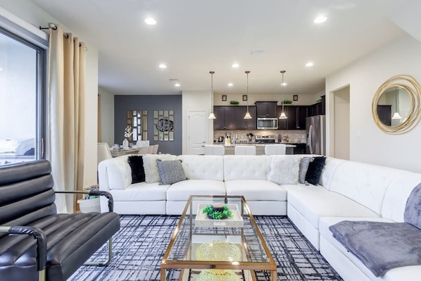 Relax in this stylish living space with a large sofa, coffee table, and comfortable chair.