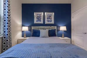 Relax in a stylish room with a large bed, two side tables, and a pair of lamps.