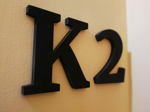 A wall-mounted sign with the letters "K2" in black.