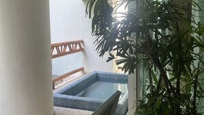 A balcony with a small pool, a potted plant, and a wooden railing. - Come and spend time in our beautiful resort, Grand Myan, Neuvo Vallarta. (Nuevo Vallarta)