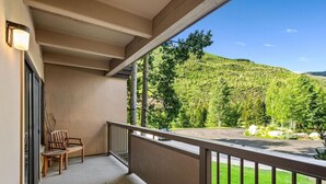 A balcony with a view of a green hillside. - Vail Home/Hot Tub On Bus Line (Vail)