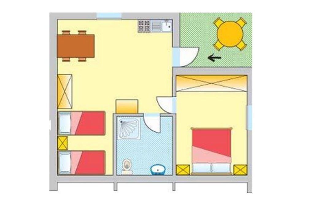 Ein Hotelzimmer mit einem Bett, einem Badezimmer, einer kleinen Küche und einem Essbereich.