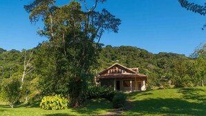 A house surrounded by lush greenery and hills. - Casa do Rio, Rio Bonito de Lumiar (Lumiar)
