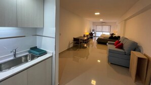 A modern apartment with a kitchen, dining area, and living room. - Modern & Cozy Studio in San Telmo With Pool and Exclusive Services no1 (Buenos Aires)