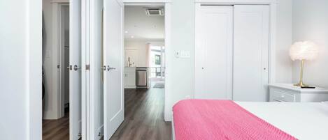 A bedroom with a bed, a nightstand, and a lamp.