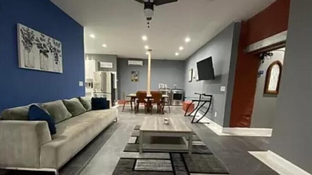 Ein Wohnzimmer mit einer Couch, einem Couchtisch und einem Essbereich.