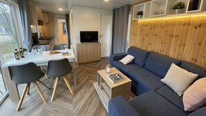 Un salon moderne avec un canapé, une table basse et un coin repas.