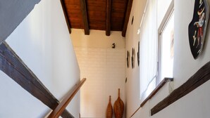 A staircase with granite steps and wooden handrails, leading to a room with white walls and a window. - Da Norma by Interhome (Terzo d'Aquileia)