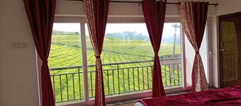 Spacious and serene space with Tea Estate view from every room.