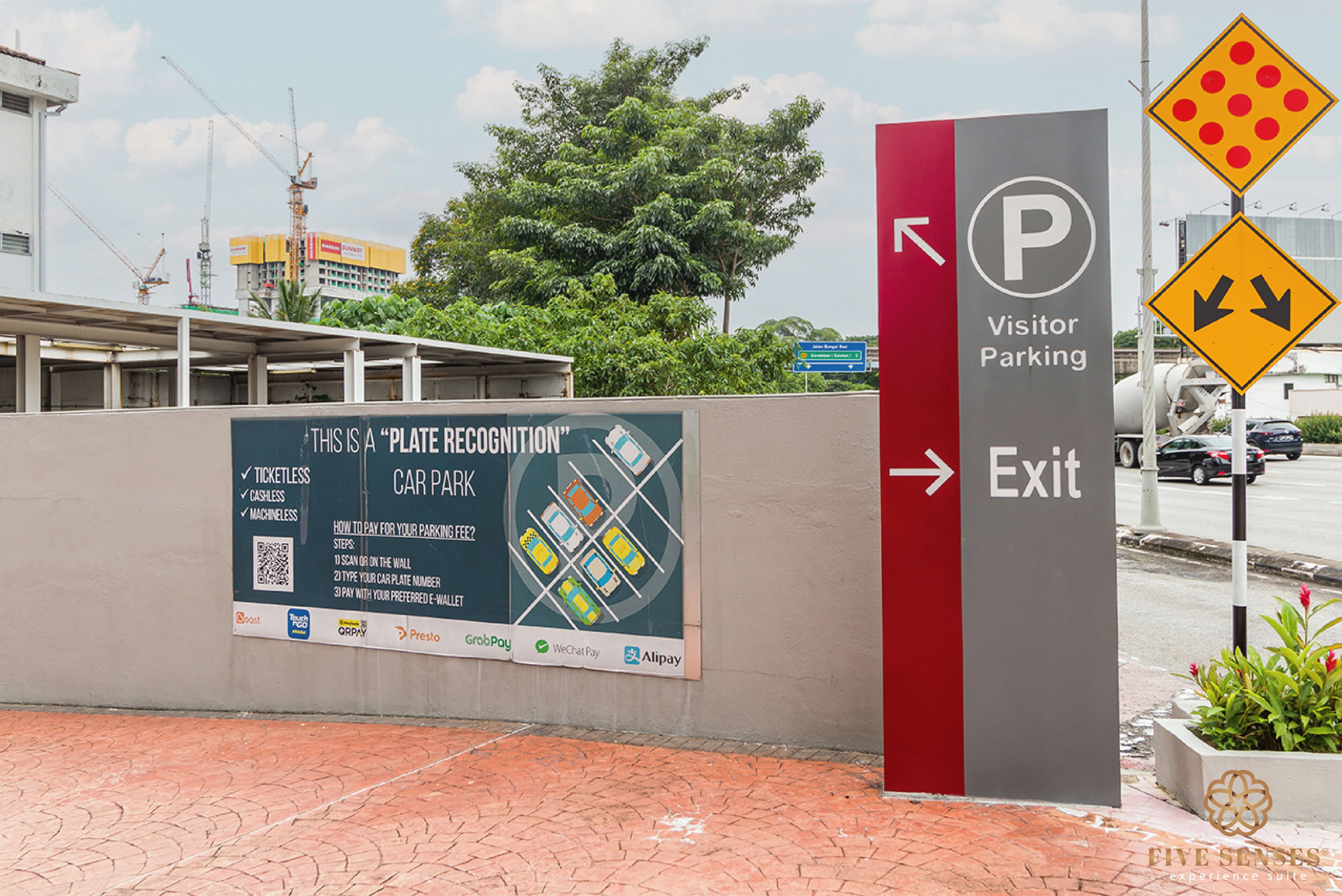 A parking sign for visitor parking with a QR code and payment options.
