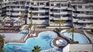 A modern hotel with multiple balconies, a central swimming pool, and palm trees. - Sara | Sea view - pool - terrace (La Cala de Mijas)
