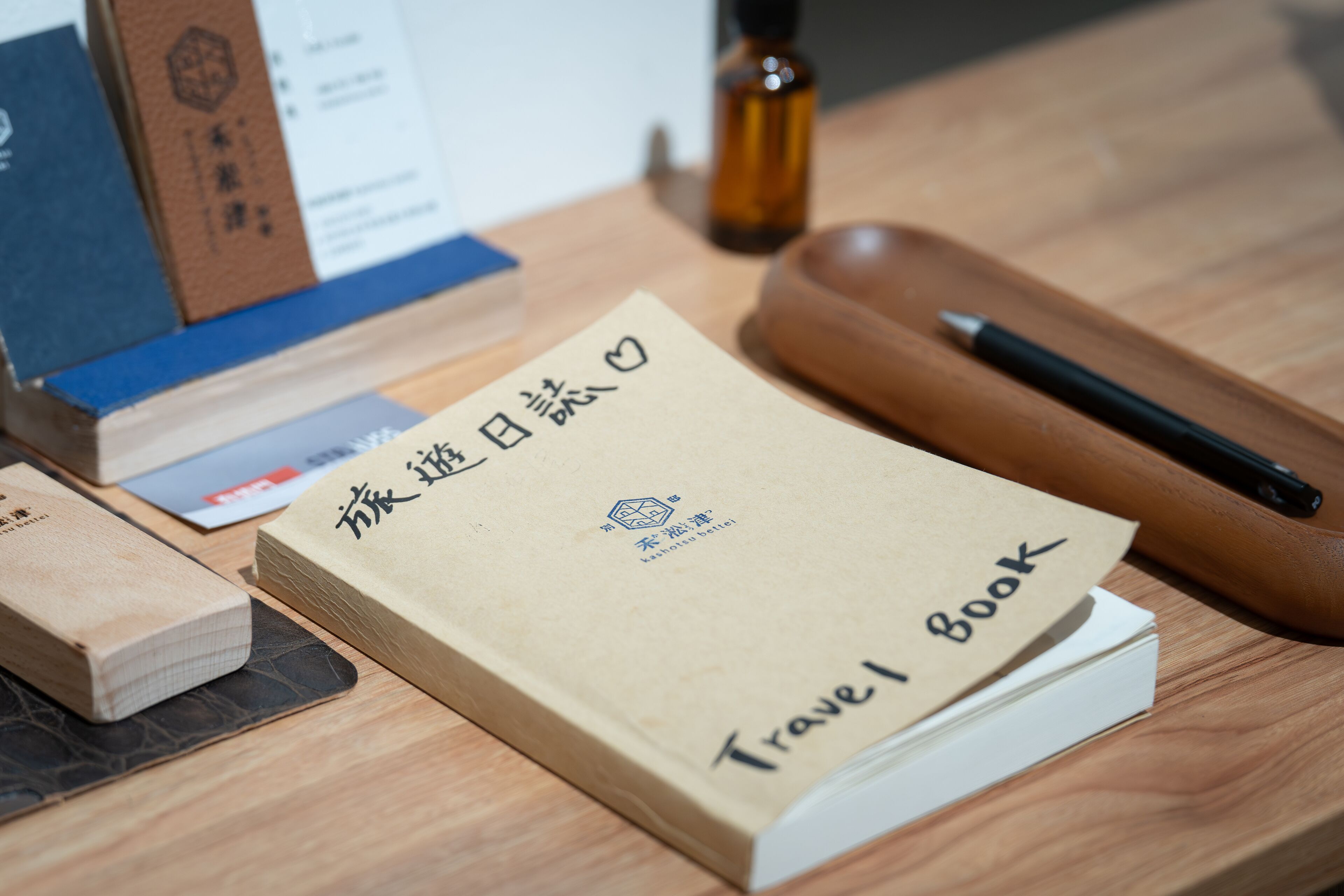 A travel book with foreign text on a wooden table.