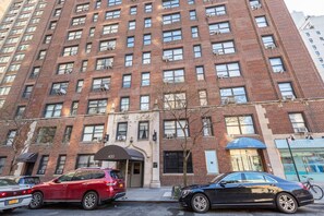 Classic architecture meets modern amenities in this elegant building with a central entrance and air conditioning.
