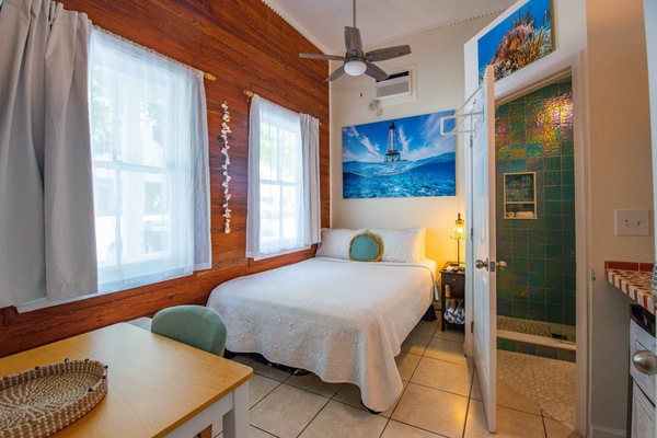 The queen bed exudes comfort and luxury, beckoning with its plush pillows, soft linens, and inviting ambiance, promising a restful retreat.