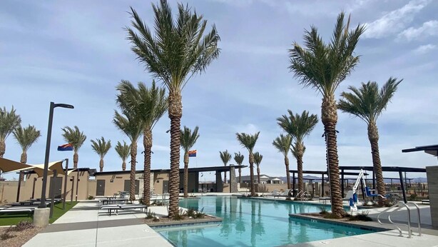 A pool area with palm trees, lounge chairs, and a flag. - 3BR w playroom, community pool/spa! (Queen Creek)