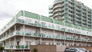 A multi-story building with balconies, a green roof, and a modern architectural design. - Skyvillion - Tower Point Enfield 1bed With Balcony (Enfield)