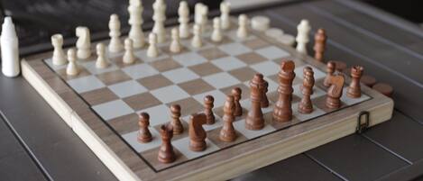 A chessboard with pieces on a table.