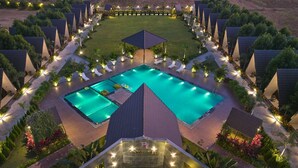 A resort with multiple swimming pools, sun loungers, and a well-maintained garden.