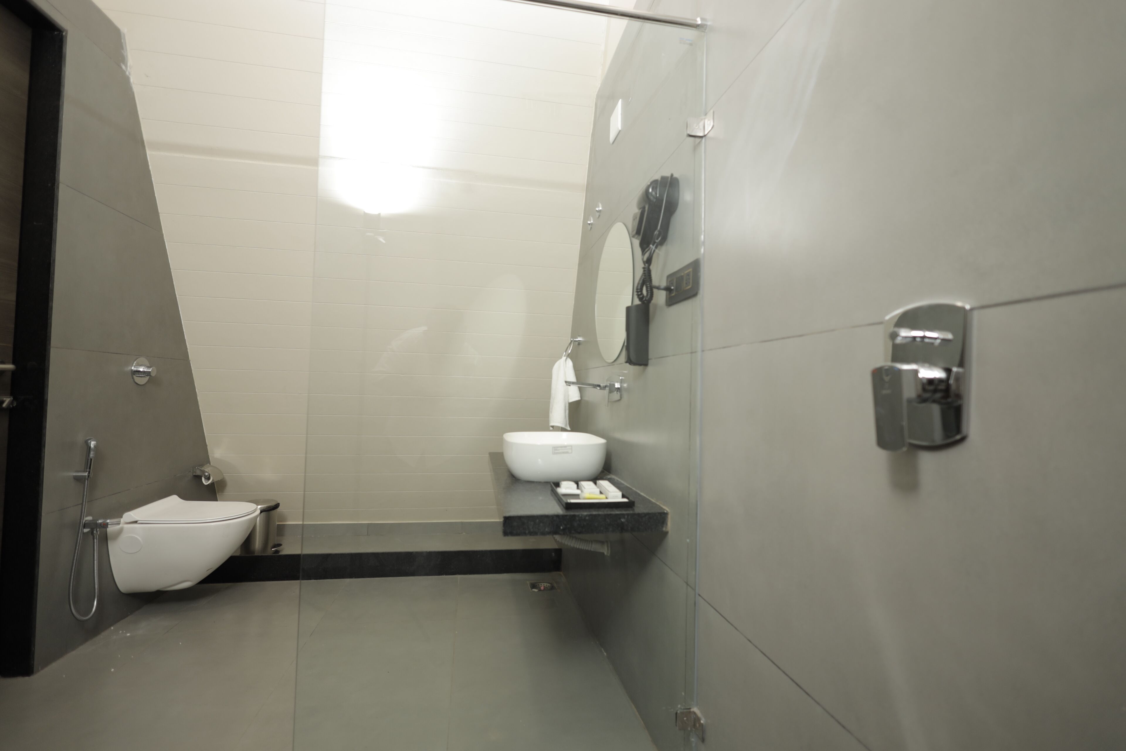 A modern bathroom with a toilet, bidet, and sink.