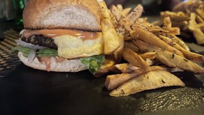 A burger with fries on a table. - Cot Hotel (Addis Ababa)