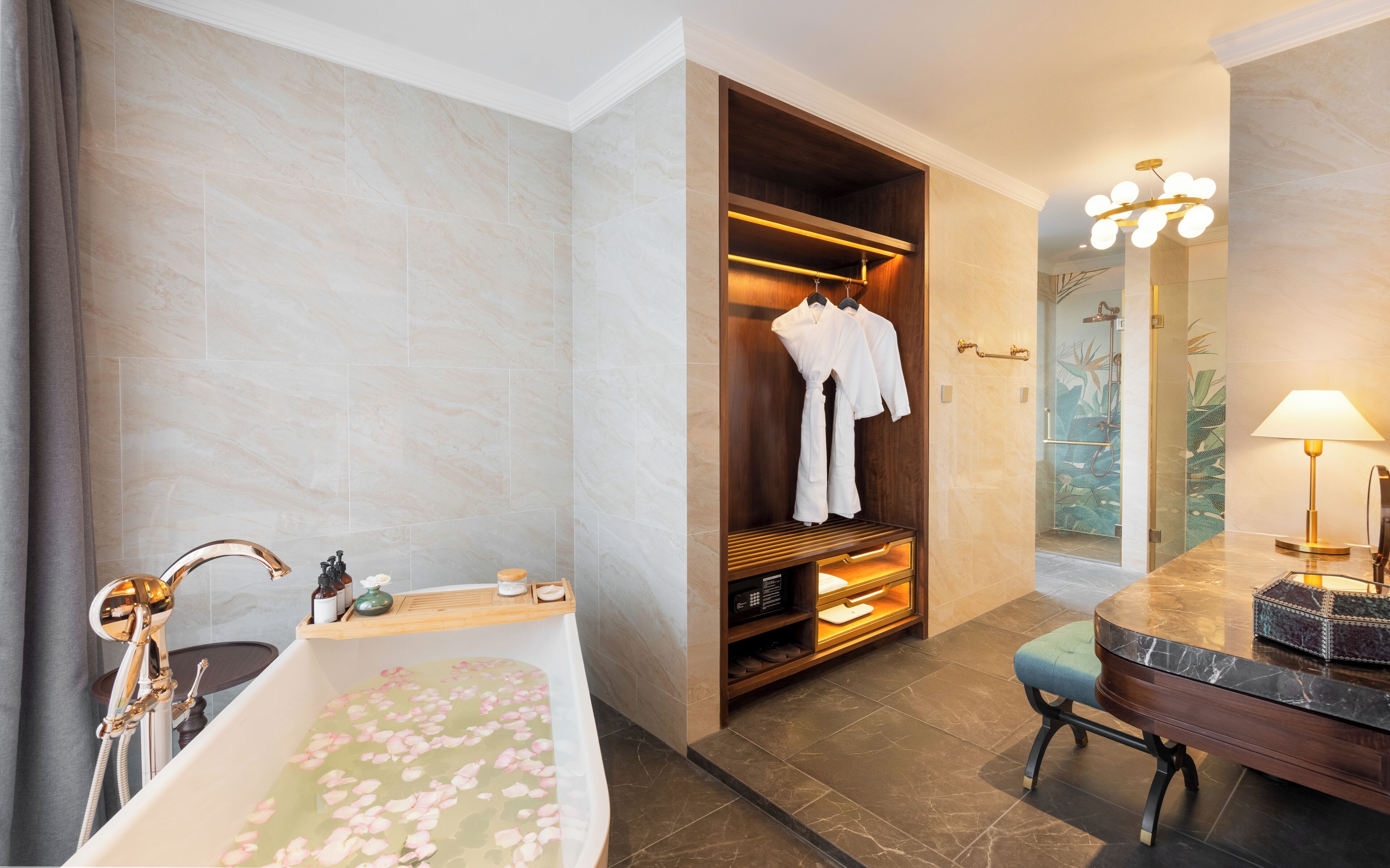 A bathroom with a bathtub, shower, robe rack, and a vanity with a mirror.