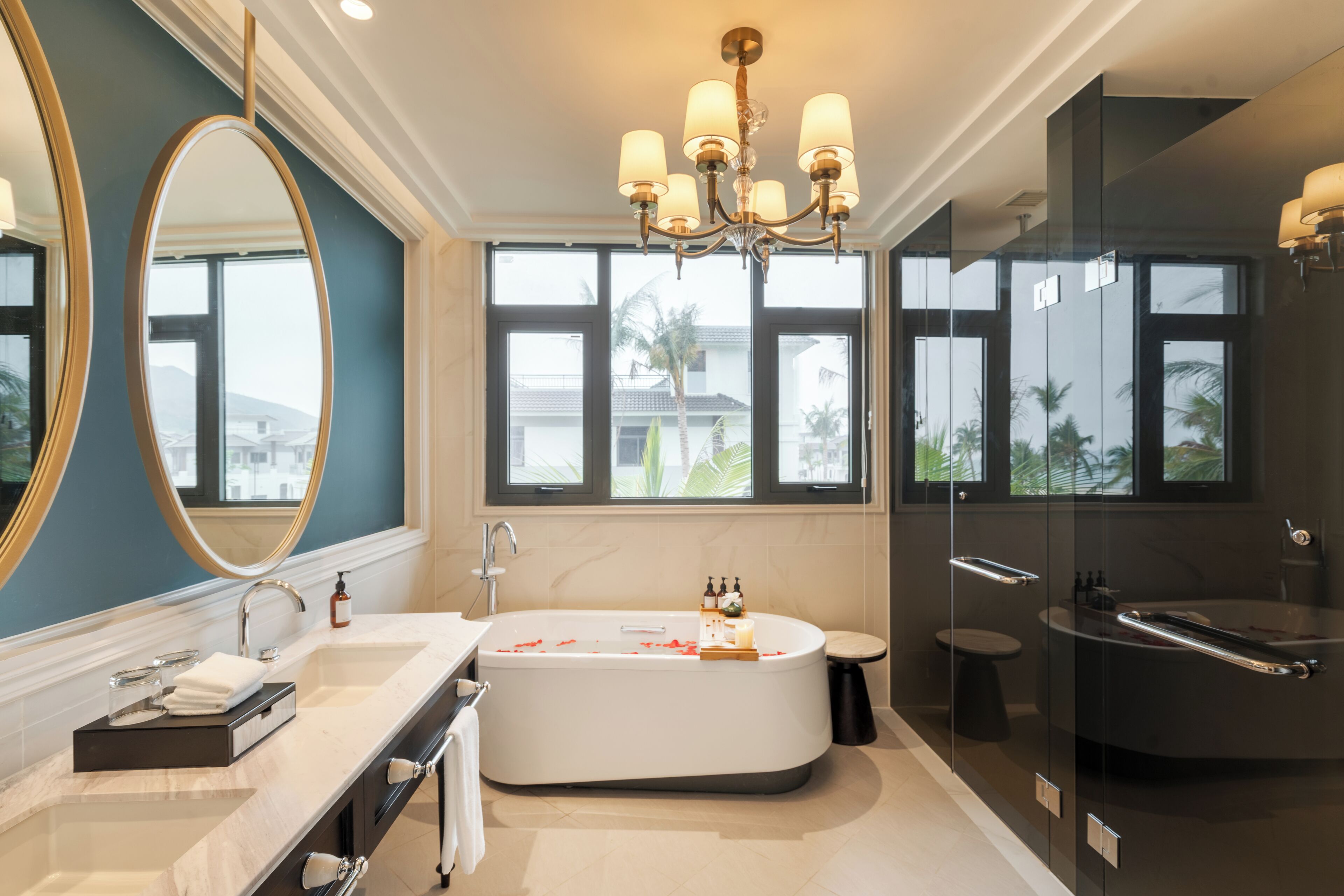 A modern bathroom with a freestanding bathtub, a large mirror, and a glass-enclosed shower.