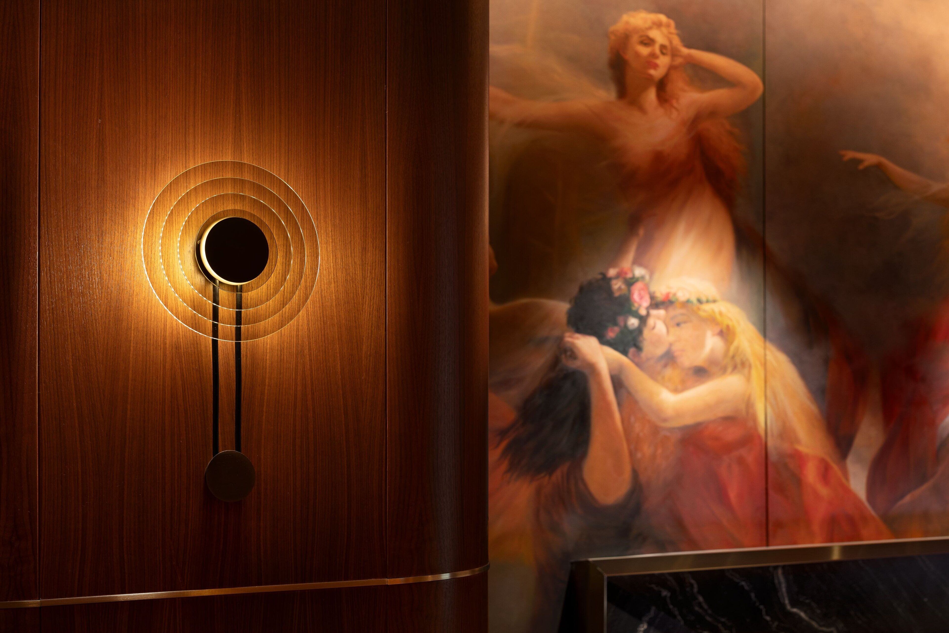 A wooden door with a circular handle and a circular light fixture.