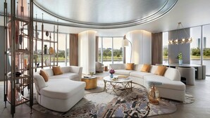 A modern living room with a curved ceiling, white sofas, a coffee table, and a large window offering a city view. - The St. Regis Belgrade (Belgrade)