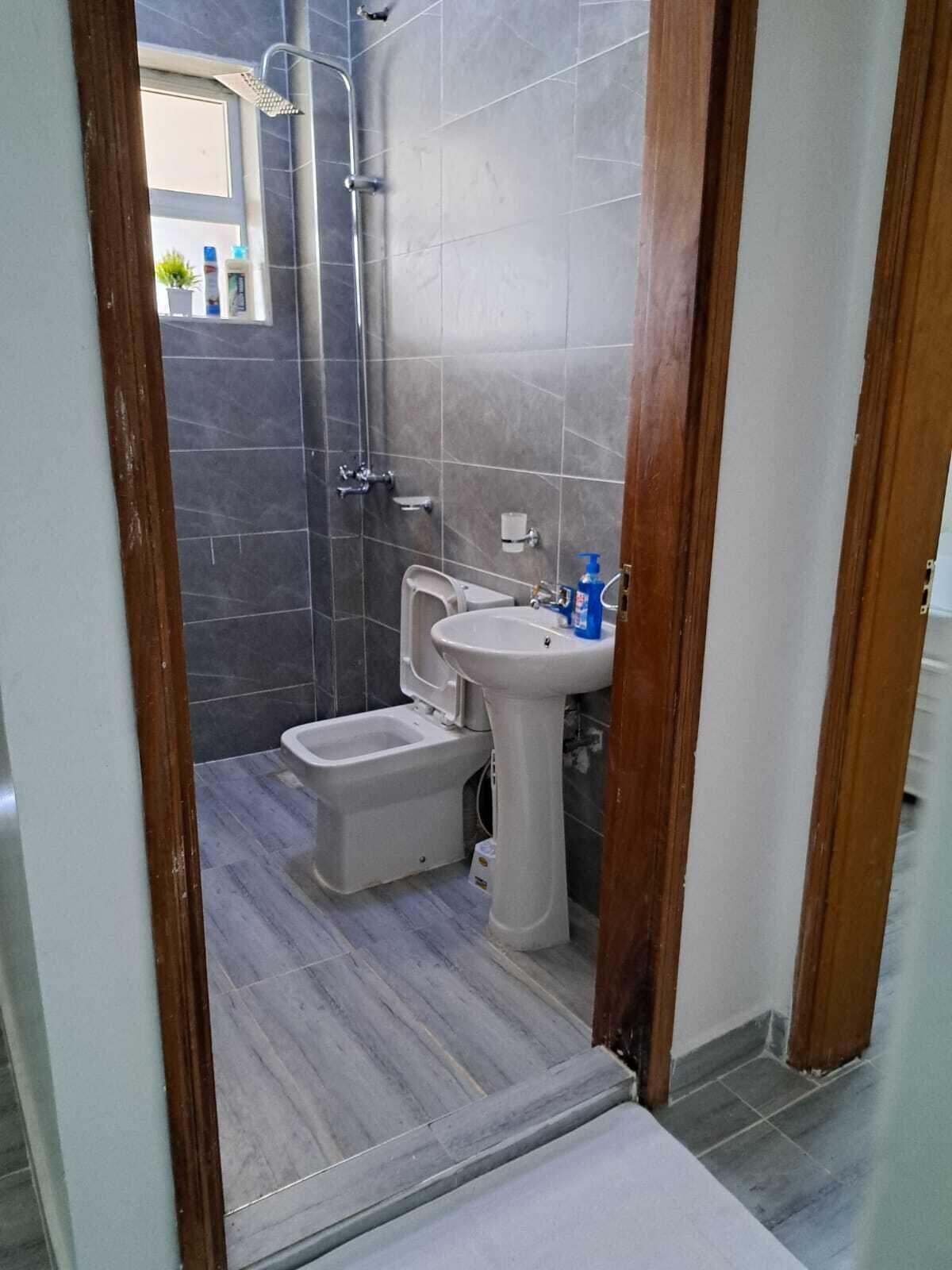 A small bathroom with a toilet, bidet, and sink.
