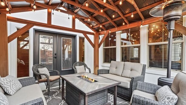 An outdoor patio with wicker furniture, a fire feature, and a ceiling fan. - Large Modern 5 Bedroom Custom Home (Meridian)