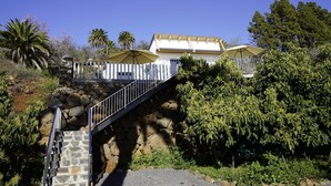 A stone staircase leading to a white building with a covered patio area. - SOL UNA Joya (CN)