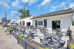 An outdoor patio with multiple tables and chairs, a building labeled 'Brewery', and another building with a 'Chef Shack' sign. - Homesmith Cottage|Hot Tub| Walk to Buckeye Lake (Buckeye Lake)