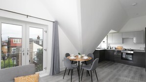 A modern apartment with a dining area, kitchen, and balcony. - Skyvillion -vineyard Court- Enfield 1bed Wbalcony (Enfield)