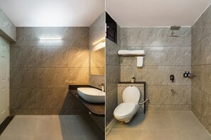 A bathroom with a marble wall, a white sink, and a toilet. - Jhadol Bagh (Jharol)