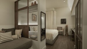 A bedroom with a bed, a sofa, a desk, and a mirror. - Ergon Bakehouse Athens (Athens)