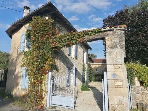 A stone lodge set in the grounds of an old farmhouse in the Charente countryside