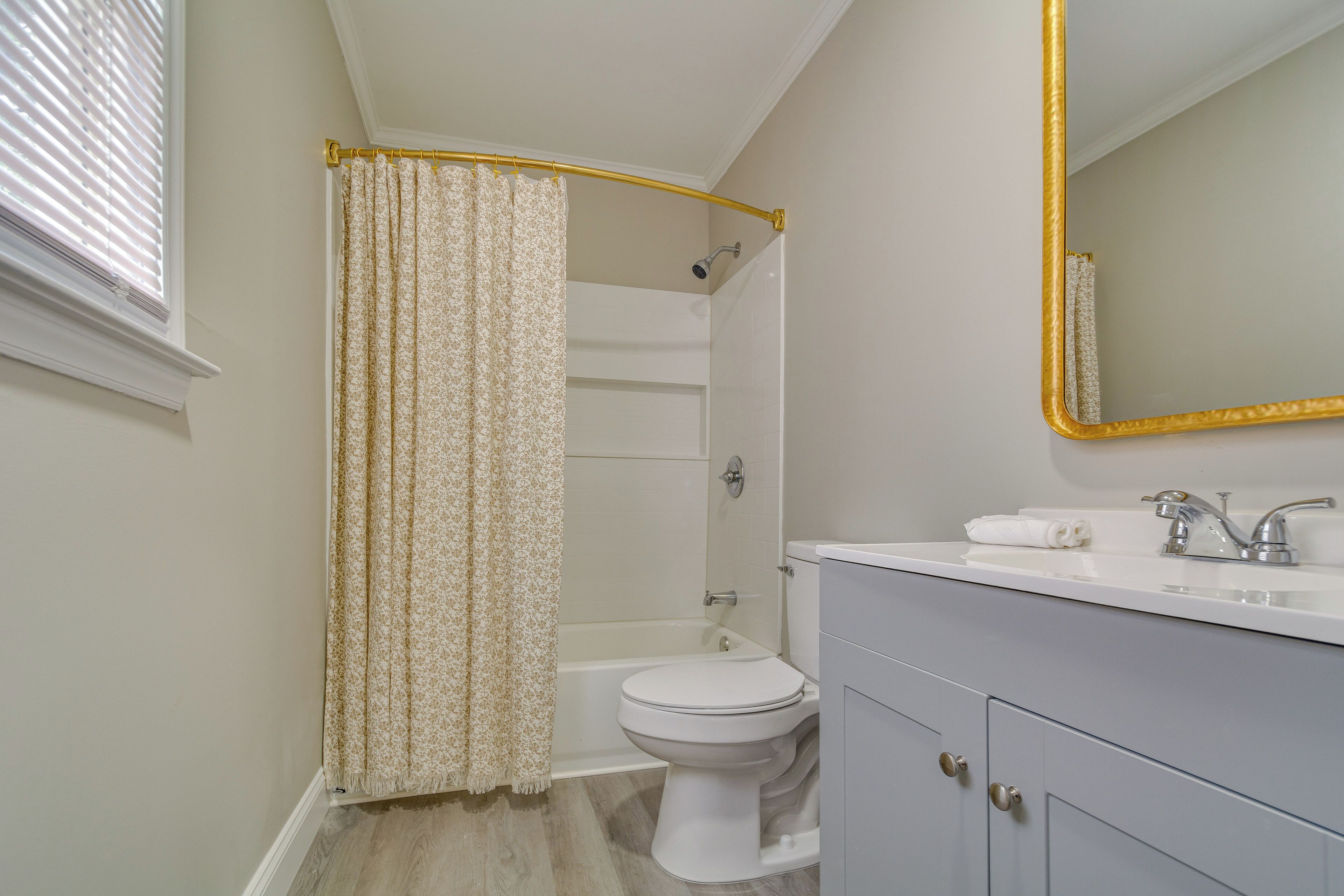 A bathroom with a toilet, sink, and shower.